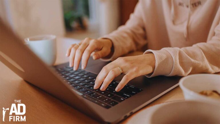 PPC ads expert working on paid search campaign strategies on a laptop.