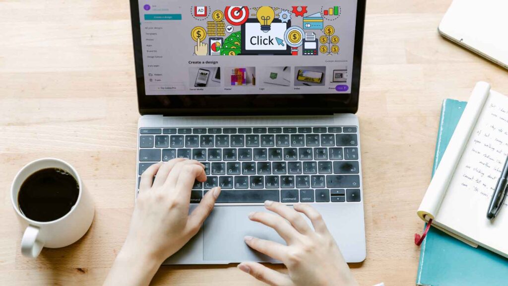 Marketer working on a laptop with PPC graphics, planning targeted PPC strategies for online ads.