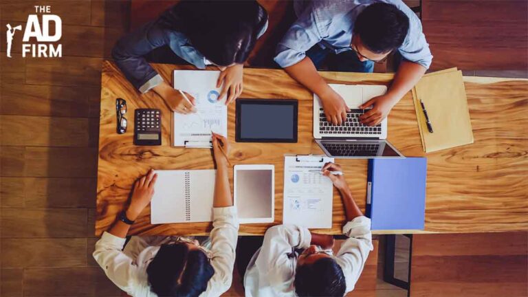 A group of professionals working on marketing analytics, incorporating gamification in marketing for better conversions.