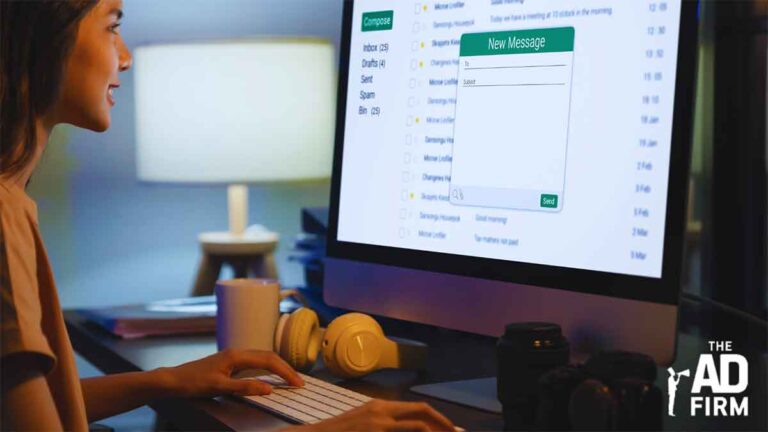 A woman composing an email on a computer screen, demonstrating content personalization in email marketing.