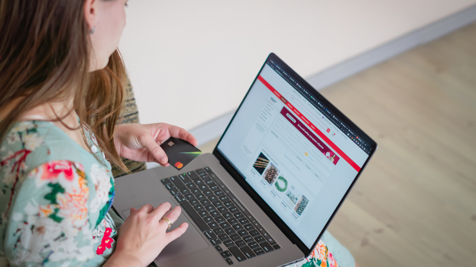 Woman shops online using a laptop and credit card