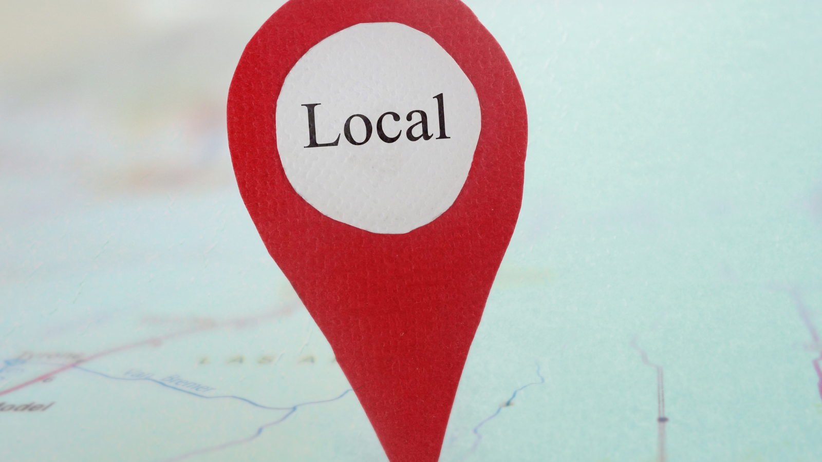Red location pin with the word _Local_ on a map