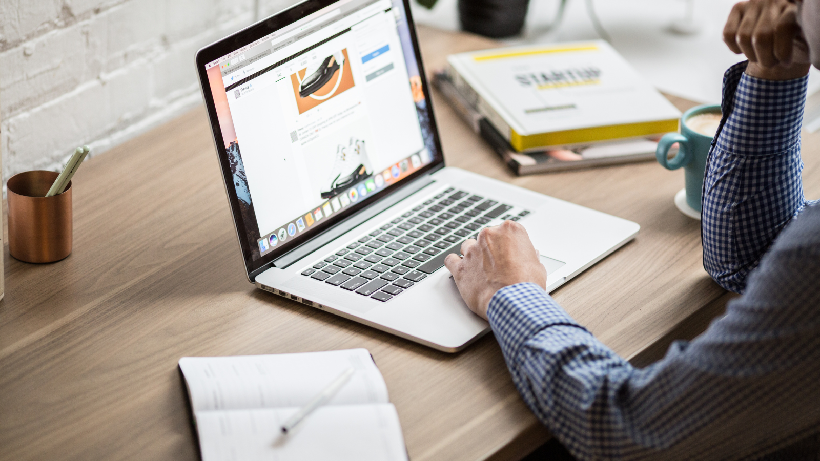 Person browsing an online store on a laptop at a desk
