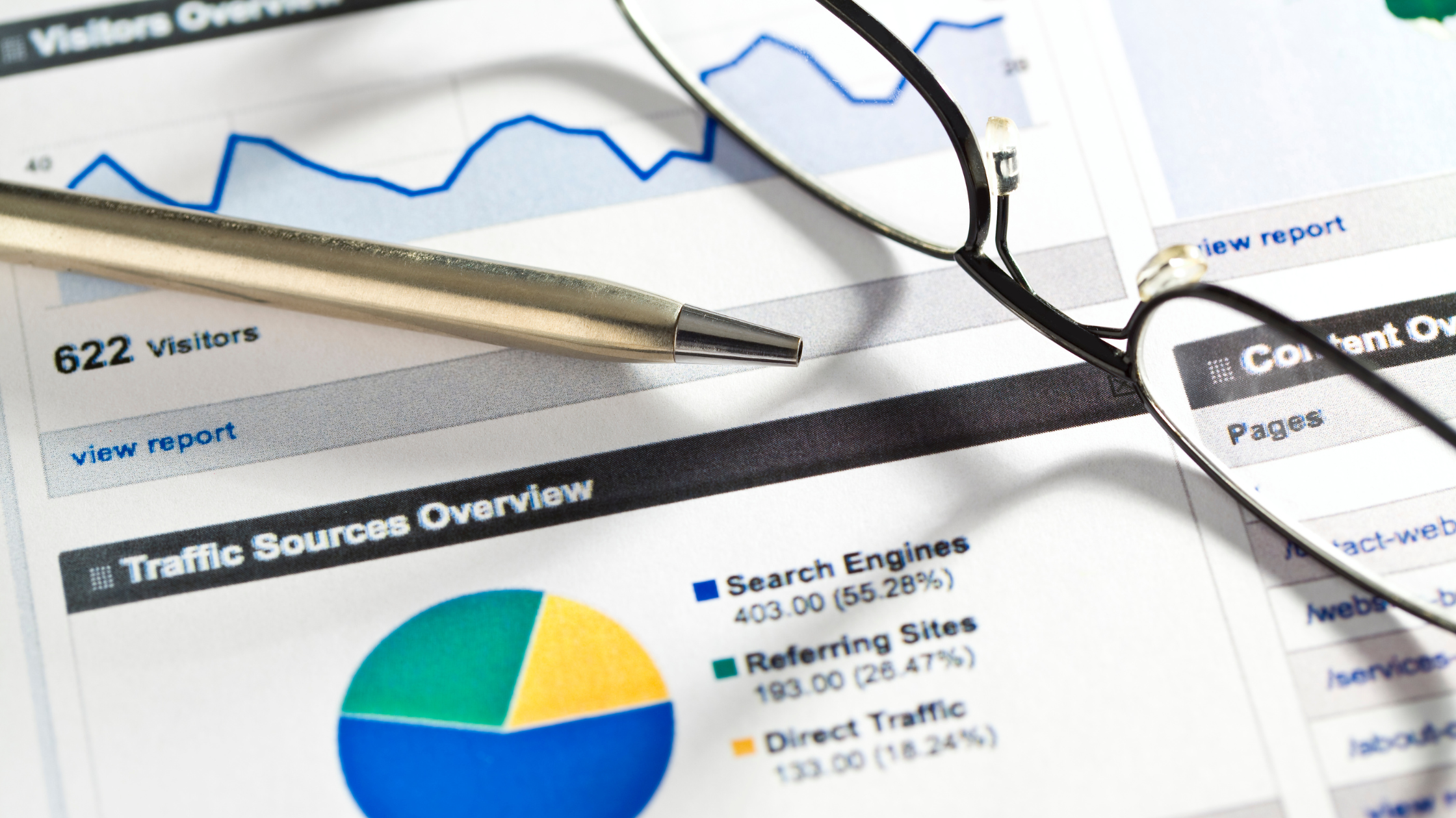Printed SEO performance reports spread across a desk