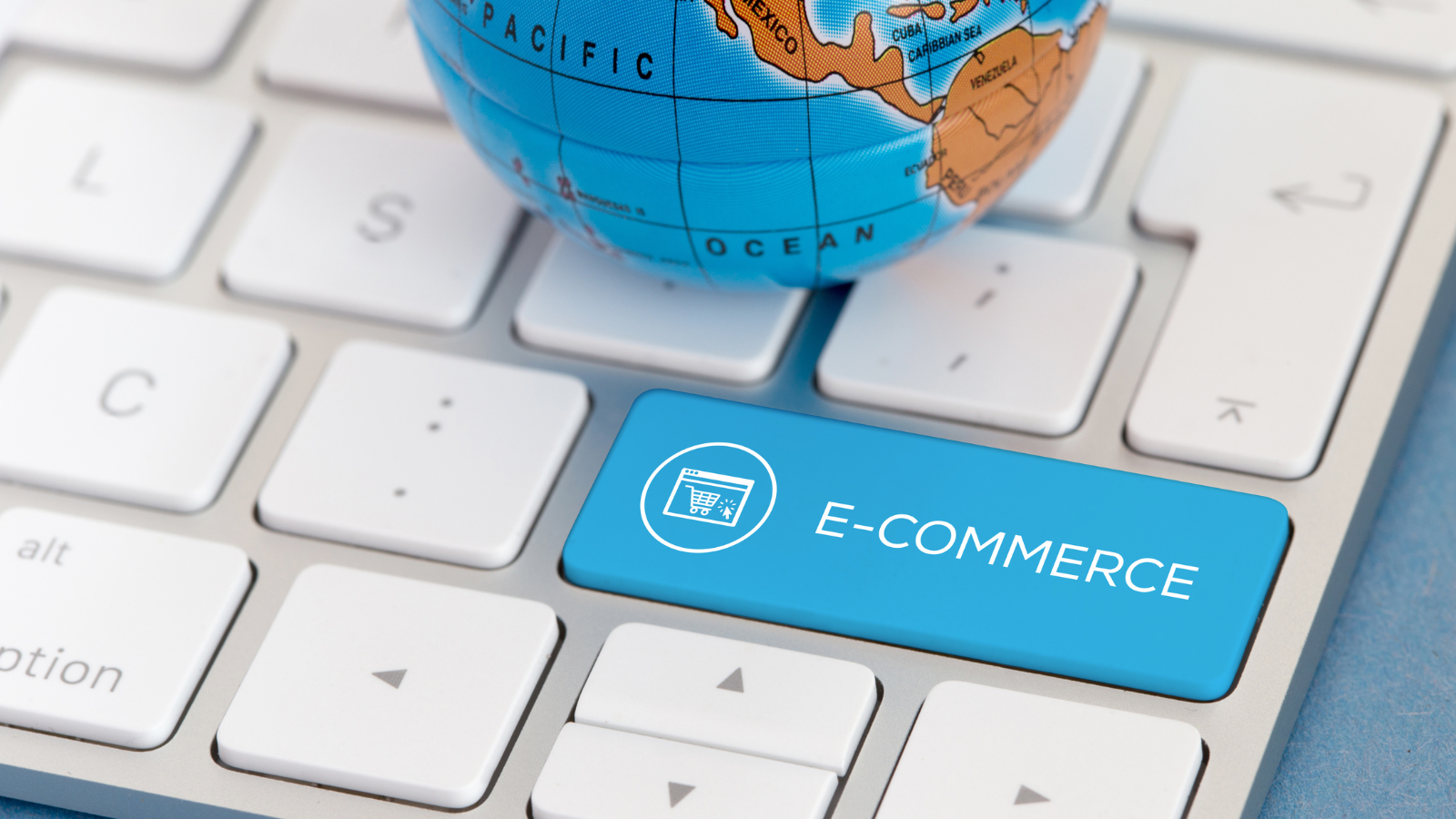 A globe placed on a keyboard with an _E-commerce_ key highlighted