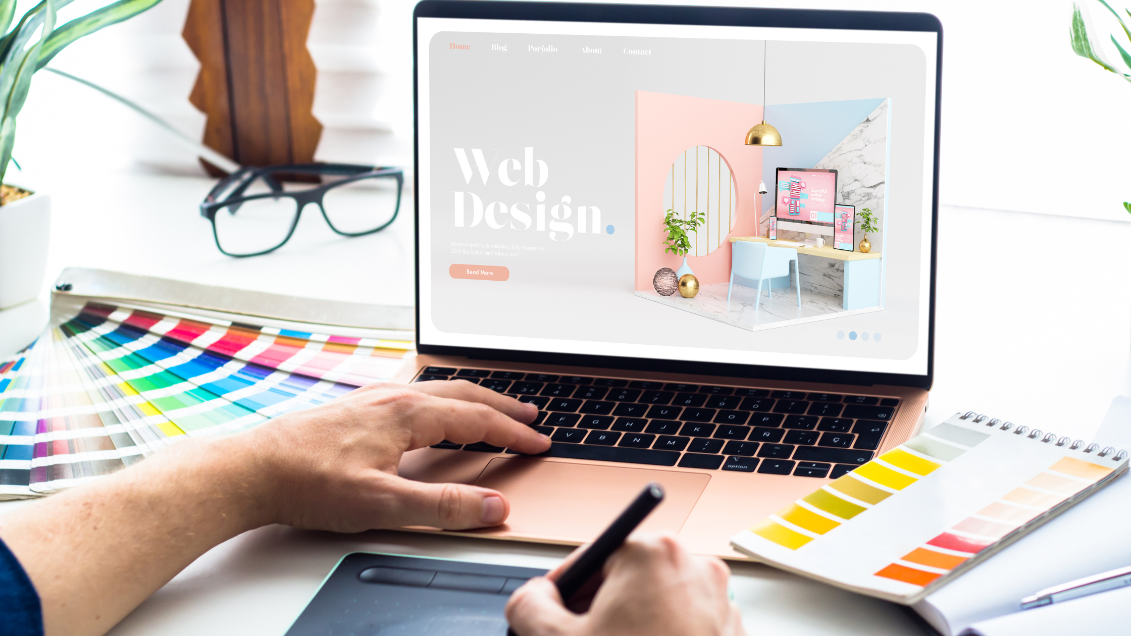 A man working on web design with creative layouts and graphics on the screen