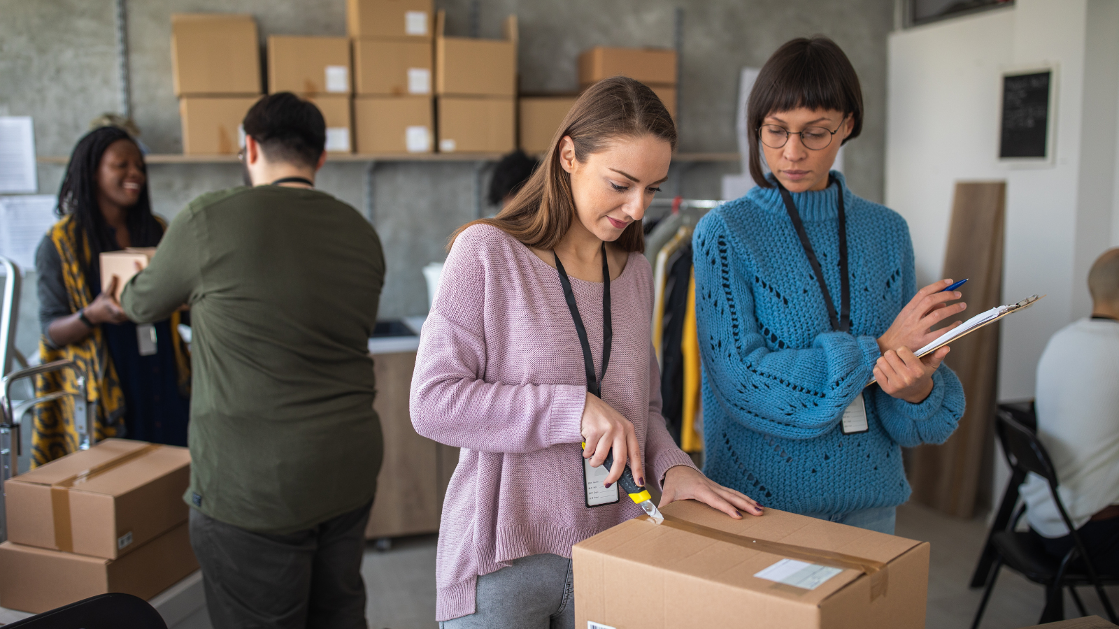 Employees packaging orders in a warehouse