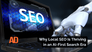 A robotic hand typing on a laptop screen displaying the word SEO