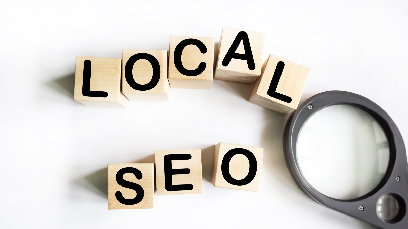 Wooden blocks spelling _LOCAL SEO_ with a magnifying glass